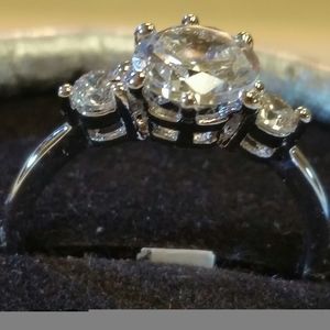 Silver, white sapphire center stone.